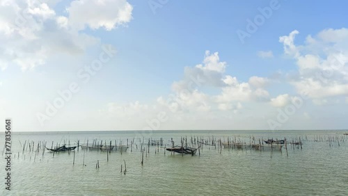 Tame lapse fish trap placed in the sea with cloud timelapse nature background.