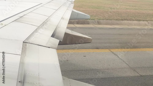 The view from the airplane window. An airplane is on the runway preparing to take off.