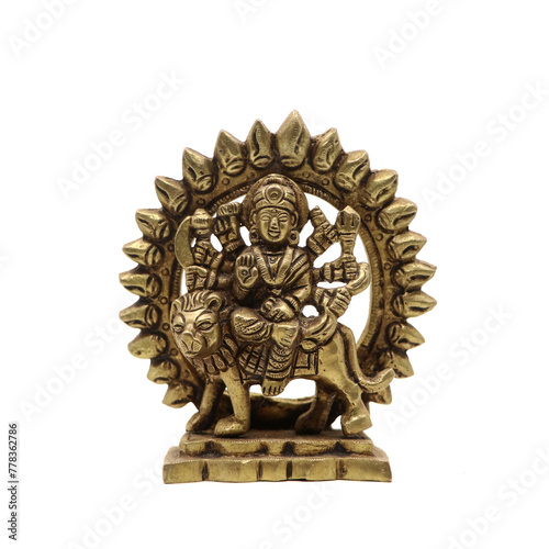 statue of goddess durga devi of hindu religion holding multiple weapons in her many arms, sitting on her lion, handcrafted with details in golden brass isolated in a white background