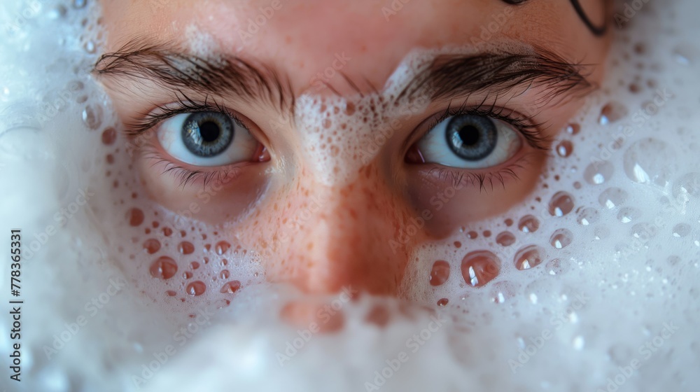 Close-up of a person's eyes looking intently through a layer of bubbles