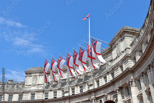 White Ensign flags flying on Admiralty Arch which connects The Mall and Trafalgar Square in London photo