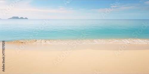 Fine art photography of an empty tropical beach with turquoise ocean and white sand under a blue sky with sparse clouds in the background