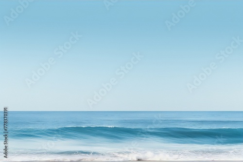 Minimalist beach photography of a blue ocean wave with a clear blue sky and white sand