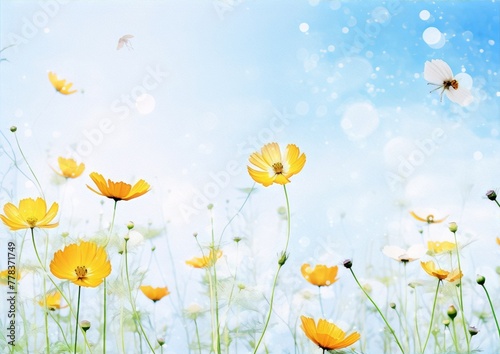 Delicate yellow and white cosmos flowers in a field under a sprinkling of iridescent soap bubbles.