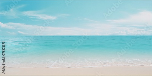 Minimalist beach landscape with turquoise ocean and white sand under a blue sky with soft clouds in background