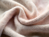 Soft cashmere, close-up, knitted texture, pastel shades.