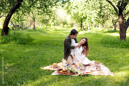 young couple in love on a picnic in summer park