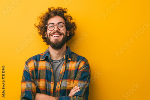 A man with a beard and glasses is smiling and posing for a picture
