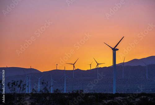 Sunset over the windmill farm in Palm Springs, California at the foot of the San Jacinto Mountains, adjacent to Highway 111, which helps provide energy for the Coachella Valley in Riverside County. photo