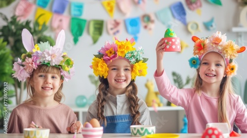 happy girls with flower crowns are smiling at a table adorned with Easter eggs, sharing in the joy of a fun arts and crafts event AIG42E