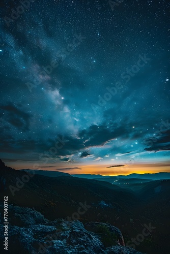 a landscape of a mountain range with stars in the sky © John