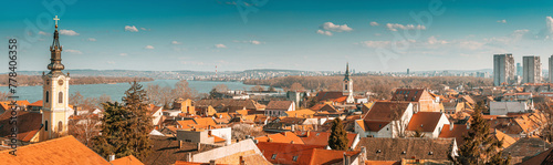 a scenic panoramic observation of Belgrade's cityscape, with its picturesque houses and historic churches lining the banks of the Danube River. photo