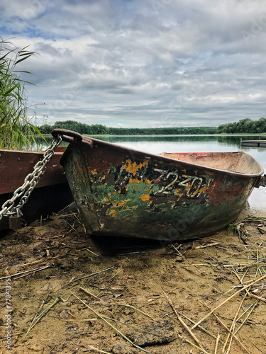 old fishing boat on the lake shore 