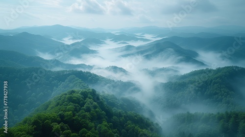  Aerial view of a mountain range in a foggy valley