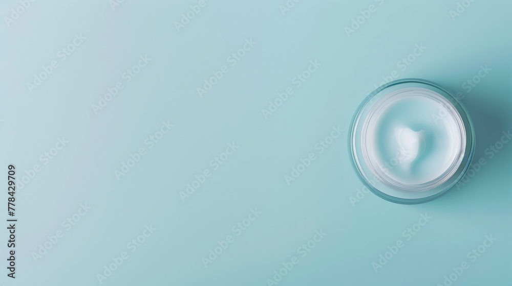 banner for advertisment of a jar of facial cream with hyaluronic acid against a light blue background with copy space, overhead view