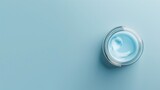 banner for advertisment of a jar of facial cream with hyaluronic acid against a light blue background with copy space, overhead view