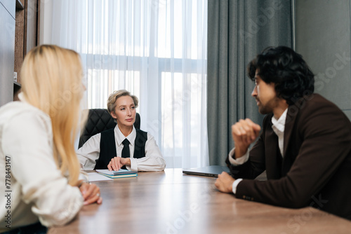 Front view of happy young couple sign paperwork with financial advisor in agency office planning budget for insurance. Banking, document and people in agreement with professional broker to invest.