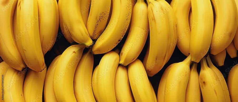   Ripe yellow bananas on a wall in a grocery store's fruit and vegetable section