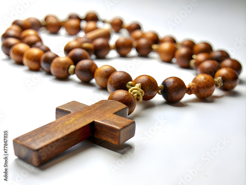 Wooden rosary and cross isolated on white background.