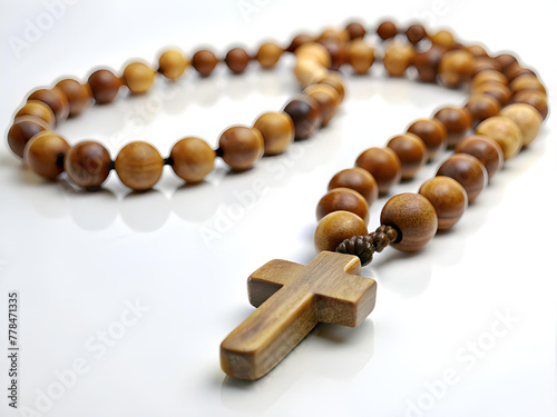 Wooden rosary and cross isolated on white background.