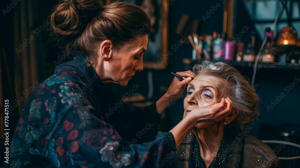 Fototapeta premium Makeup artist at work with an elderly woman, backstage preparation for theater or film, suitable for content on beauty, aging, entertainment industry.