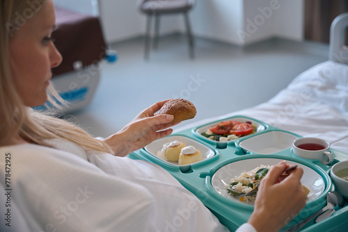Fotografie Hospitalized woman having lunch in inpatient facility ward