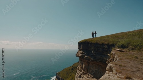 People on a cliff over the ocean