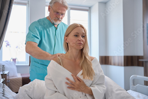 Canvas Print Clinician performing pulmonary auscultation of inpatient during ward round