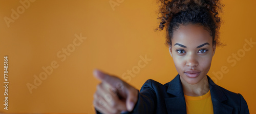 Woman Crossing Arms in Front of Yellow Wall