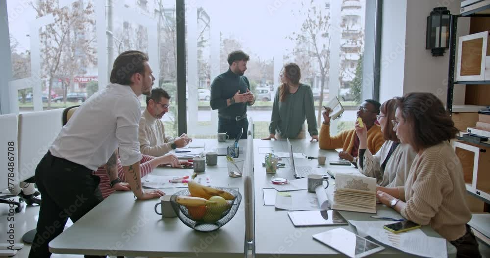 A multicultural team of corporate employees engaged in a strategy discussion during a business meeting in a modern office setting. A multicultural team of corporate employees engaged in a strategy discussion during a business meeting in a modern office setting.