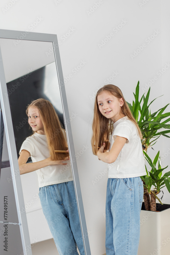Child Girl Brushing Hair in Mirror. Morning preparation before school. Child Girl Brushing Hair in Mirror. Morning preparation before school.