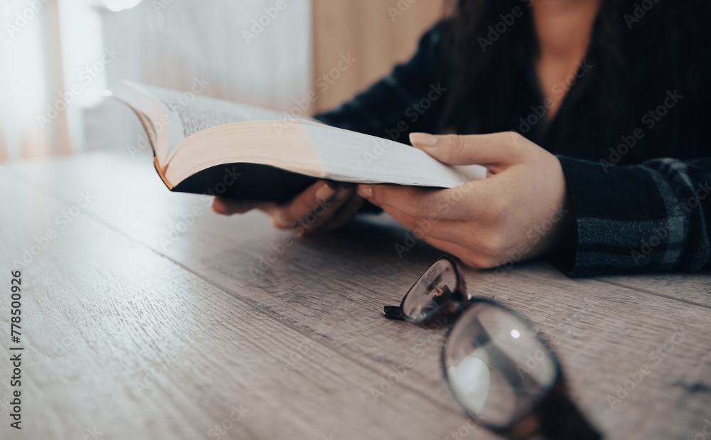 Obraz premium Woman reading holy book, hands close up. stock photo