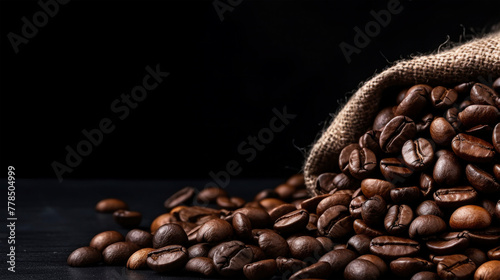 Brown coffee beans scattered wit a sack isolated on black background, beans for coffee cappuccino, espresso, latte machiato photo