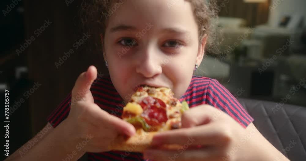 Close up Portrait child happy little girl eagerly eat delicious pizza at home,smiling child looking at camera at home eating Italian pizza, kid child with pretty face eagerly. Concept happy childhood Close up Portrait child happy little girl eagerly eat delicious pizza at home,smiling child looking at camera at home eating Italian pizza, kid child with pretty face eagerly. Concept happy childhood