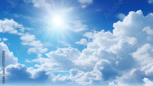 Closeup of cloudy sky with white clouds in blue heaven with shining sun