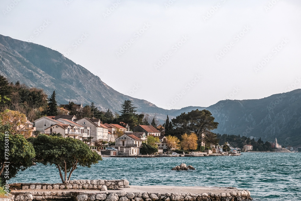 Panoramic landscape with old church in Kotor, Montenegro.Harbor and boats on a sunny day in Boka Kotorska bay, Montenegro, Europe