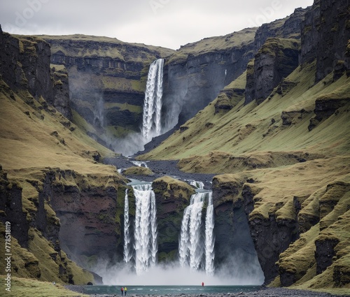 A large waterfall in the middle of a green valley surrounded by mountains.