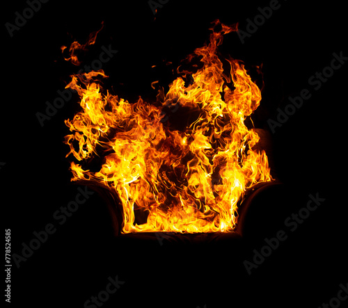 burning office chair on a black isolated background, all in fire and smoke