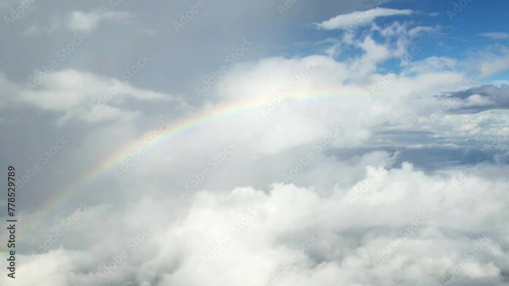A rainbow seen to the right above the clouds A rainbow seen to the right above the clouds