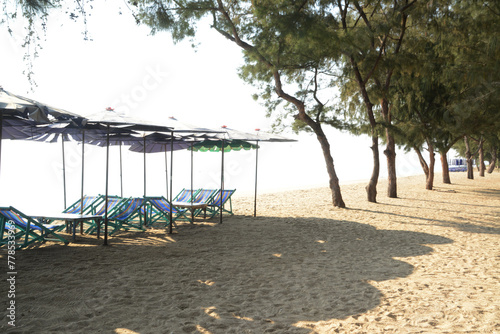 Beach deck chairs and umbrella in the morning at Cha-am Beach. Located at Phetchaburi Province in Thailand.