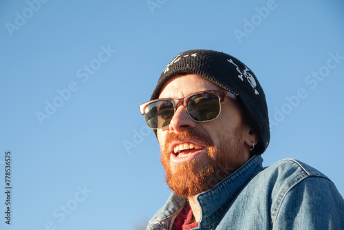 Hombre sonriente usando gafas de sol © Leonardo