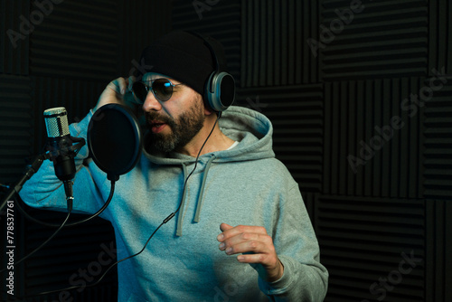 Recording artist singing a song in a soundproof studio
