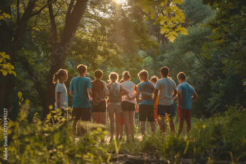 Shot of a group of kids standing in a circle in nature at summer camp photo