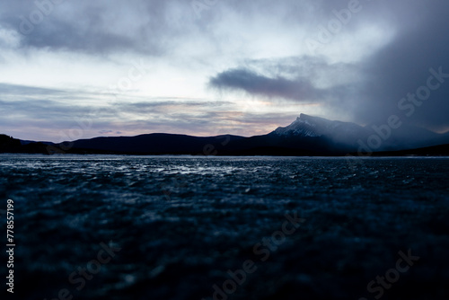 Mountain on a frozen lake during sunrise. 
