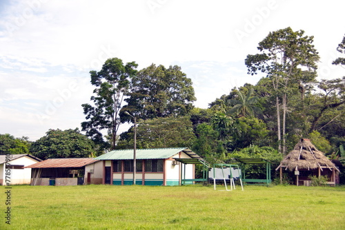 Houses and buildings around a large field in Puerto Bolivar, in the Cuyabeno Wildlife Reserve, outside of Lago Agrio, Ecuador
