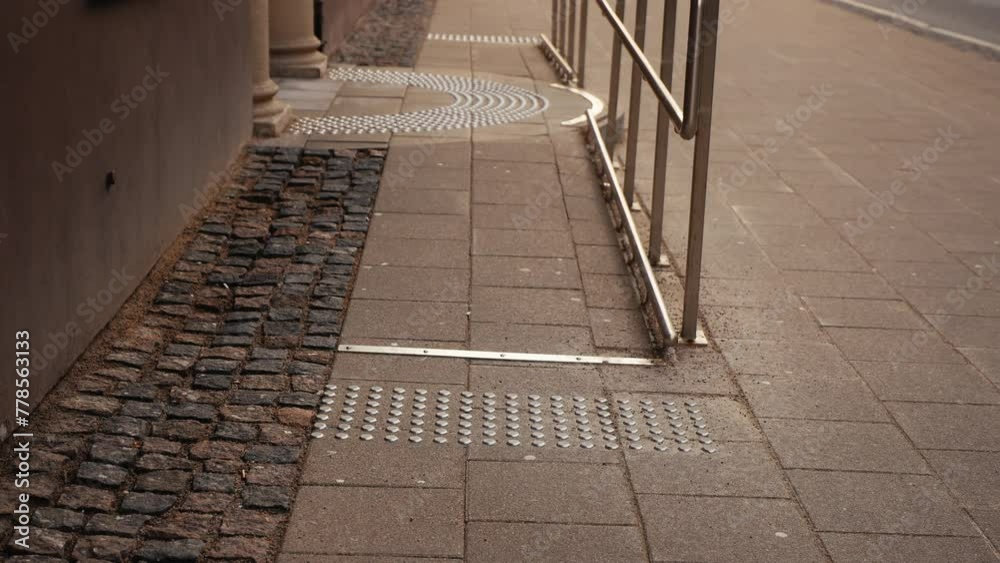 Cityscape inclusivity: Elevated vantage point capturing tactile pavement with braille indicators, ensuring accessibility in the urban landscape