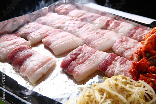 Pork belly that is cooked on a Korean-style grill