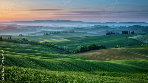A peaceful countryside landscape at dawn  with rolling hills  a patchwork of farmland  and the first light of day breaking over the horizon.