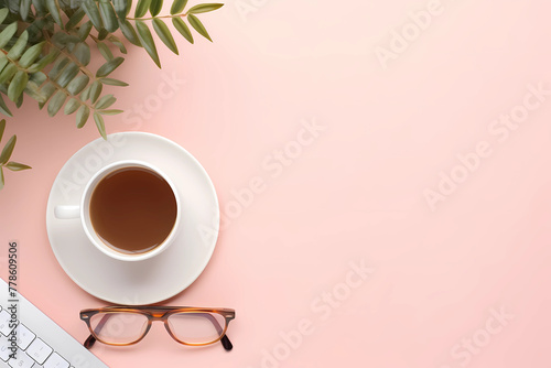 Minimalistic pink background with a coffee cup, glasses and keyboard on the right side of the picture