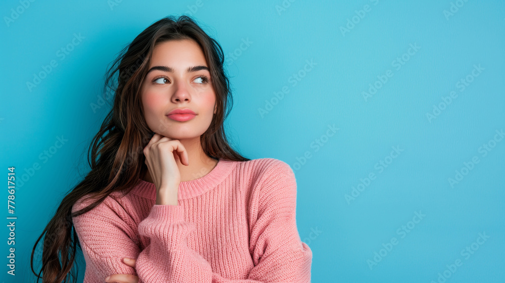 Portrait of pretty lady dressed pink knitted shirt arm chin looking empty space isolated blue background. Portrait of pretty lady dressed pink knitted shirt arm chin looking empty space isolated blue background.